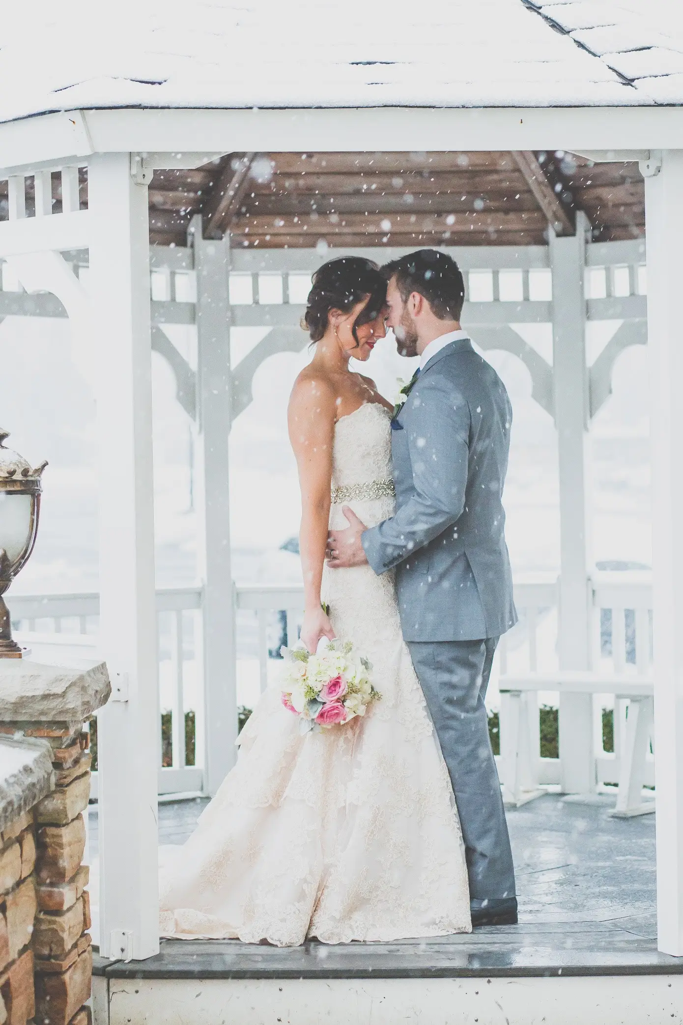 Ceremony space at Cotillion Banquets: sheer drapes, crystal chandelier, and candlelit aisle